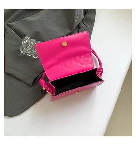 Top view of vibrant magenta quilted handbag with flap design and metal magnetic buckle