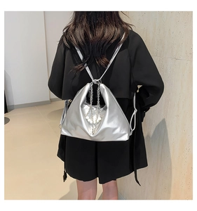 Detail view of silver metallic shoulder bag with pearl accents and chic chain strap