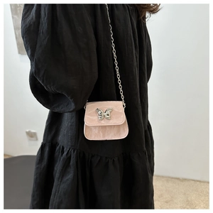 Détail du mini sac bandoulière rose texture marbre avec boucle papillon en métal argenté