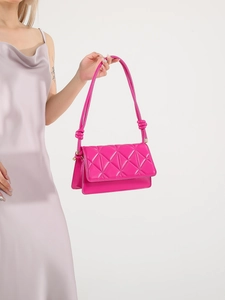 Glossy bright pink quilted underarm bag with knot strap detail and a sleek flap design
