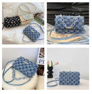 Detailed close-up of denim crossbody bag with fringe trim and stylish chunky chain