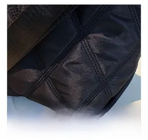 Close-up detail of the quilted diamond pattern and fine stitching on the black bucket bag