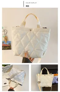 Detailed view of beige quilted tote bag showing nylon texture and adjustable strap