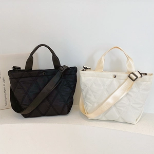 Chic quilted diamond stitch tote bag in black and off-white with adjustable shoulder strap