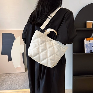 Stylish white quilted crossbody bucket bag with adjustable wide strap for women