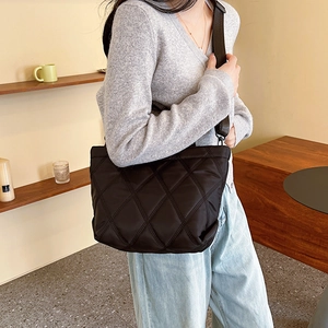 Fashionable black quilted rhombus tote bag with wide strap for casual autumn style