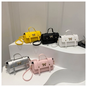Detailed display of five colorful PU leather handbags with golden bow metal buckles