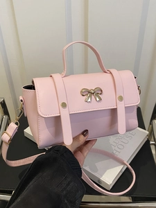 Elegant pink mini handbag for women with golden bow buckle and adjustable crossbody strap