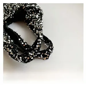 Detail shot of the wide sequin shoulder strap and exquisite stitching on black tote