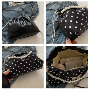 Detailed views of polka dot bucket bag showing pearl handle and interior storage capacity
