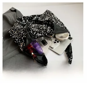 Macro view showing spacious interior of sequin shoulder bag with daily essentials