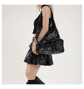 Detail of high-density black sequins and metallic texture on a large shoulder tote bag