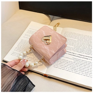 Detail of pink marble pattern mini bag with heart lock and white pearl handle