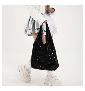 Detail of a large black sequin tote bag with a matching small zipper coin pouch