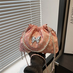 Pink polka dot canvas drawstring bucket bag with pearl handle and butterfly decor