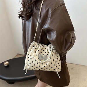Korean style polka dot bucket bag with pearl handle and metal butterfly charm strap