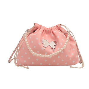 Pink polka dot drawstring bucket bag with pearl handle and silver butterfly charm