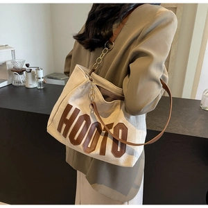 Canvas tote bag with brown leather HOOTO lettering detail on shoulder strap for women