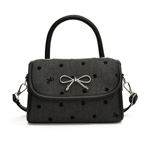 Chic black and grey herringbone crossbody bag with polka dots and silver bow clasp