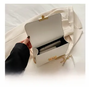Top view showing the spacious interior of a white leather straw bag with gold chain strap