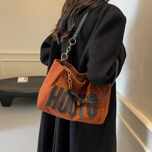 Brown suede tote bag with HOUTO lettering and gold chain strap for women
