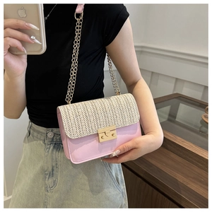 Close-up of pink and white woven crossbody bag with gold chain and metal lock