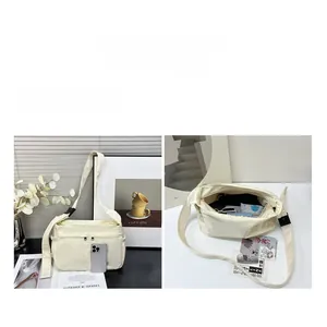 Detail view showing large interior capacity and functional compartments of the cream tote bag