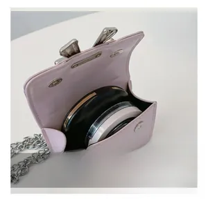 Pink chain crossbody bag internal view showing space for cosmetics and magnetic snap closure