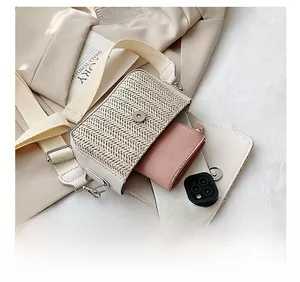 Internal capacity of beige woven crossbody bag showing smartphone and pink wallet detail