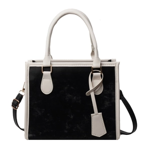 Bolso tote de terciopelo negro con asas de cuero blanco y detalles de metal dorado para mujer