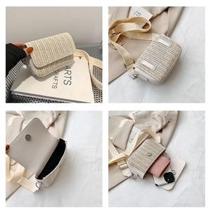 Detail view of woven straw crossbody bag with magnetic flap and canvas strap