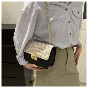 Detail of color-block straw crossbody bag with golden chain and metallic buckle