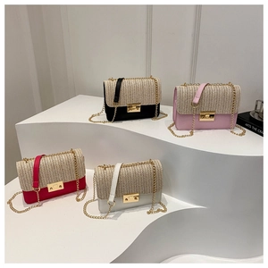 Detail of colorful woven straw crossbody bags with metal chains and gold clasps
