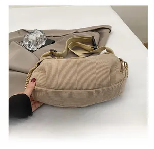 Detail of beige corduroy shoulder bag showing wide strap and durable texture