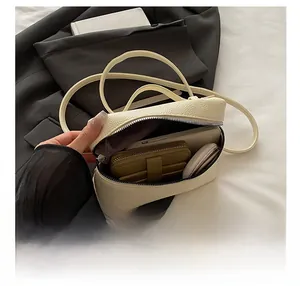 Detail view showing interior capacity of beige lychee texture leather lunchbox bag