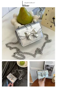 Detail view of silver glossy mini square bag with metallic bow and chain strap