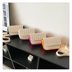 Straw woven crossbody bags in black, white, pink and orange with canvas straps