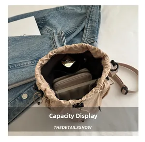 Interior view of beige nylon bucket bag showing storage capacity for phone and wallet