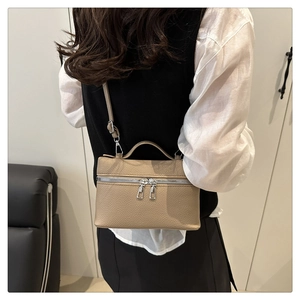 Chic beige lychee grain lunch box bag worn by a model as a crossbody purse