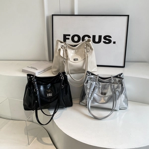 Three minimalist large capacity tote bags in cream, black, and silver with metal chain straps