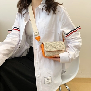 Fashionable woven crossbody bag with orange leather trim and wide fabric shoulder strap