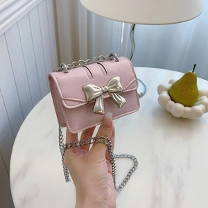 Chic pink textured PU leather crossbody bag with a silver metal bow buckle and chain strap