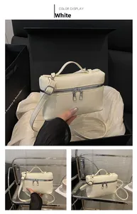 Close-up of cream white lychee pattern leather handbag with silver double zippers