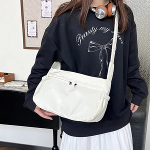 Minimalist white nylon crossbody bag for commuting with large capacity and adjustable strap