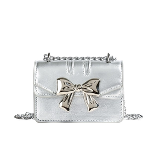 Chic silver metallic leather crossbody bag with a large polished metal bow and chain strap