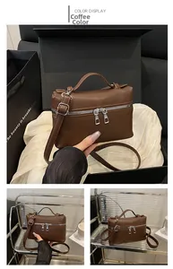 Detail view of the coffee lychee pattern leather lunchbox bag with silver hardware