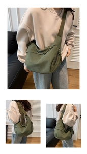 Detail view of grass green corduroy dumpling bag with woven zipper pull and wide strap
