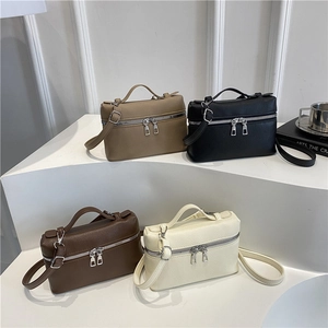Litchi pattern leather handbags in khaki, black, brown and white on display stand