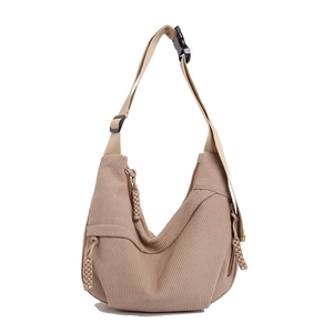 Minimalist corduroy crescent crossbody bag in beige with adjustable strap and textured fabric