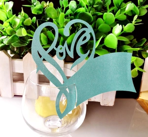 Close-up of Tiffany blue heart-shaped laser-cut place card with Love design on glass